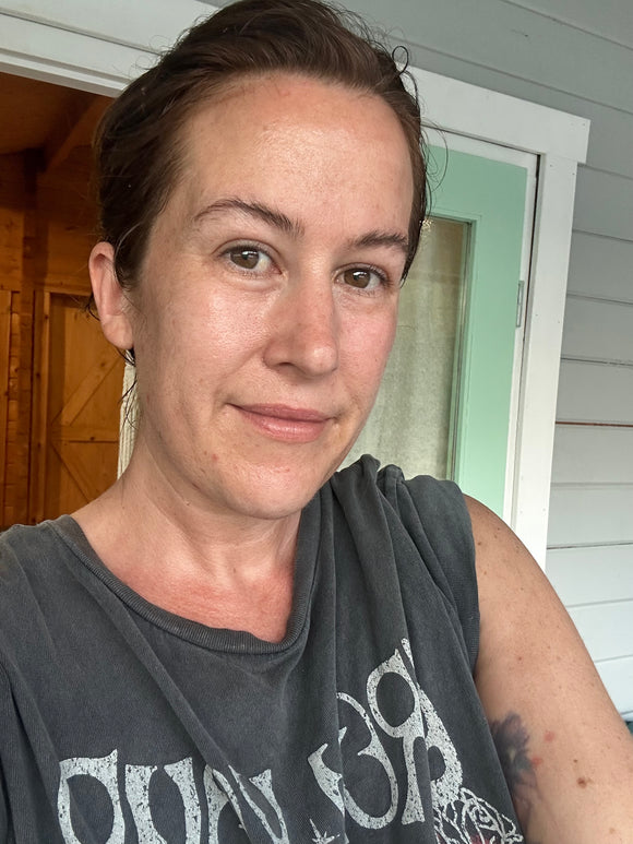 Woman wearing no makeup, just the bronzing salve